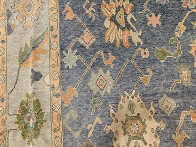 Framed motif on a blue & green Oushak Turkish area rug.