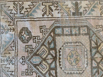 Corner of small brown and grey Sivas Turkish rug