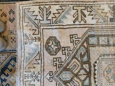 corner of a small brown and grey Sivas Turkish rug.