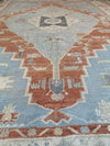 Top arch of Red and orange Oushak Turkish area rug.