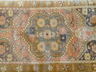 Top down view of a small blue & green Guney Turkish rug.