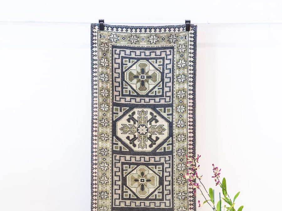 Hanging blue & green Oushak Turkish rug.