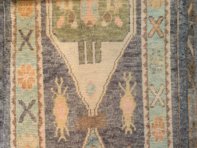 Close up of knot-work on a blue & green Turkish runner rug.