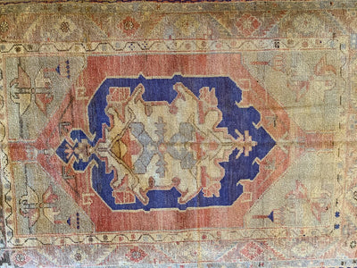 Central blue medallion on a small blue & green Cal Turkish rug