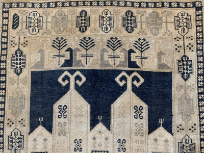 Close up on ornamentation and me repeated medallion patterns on a blue & green small Sivas Turkish Rug.