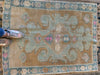 Woman in pink sneakers standing on blue & green small Sivas Turkish Rug.