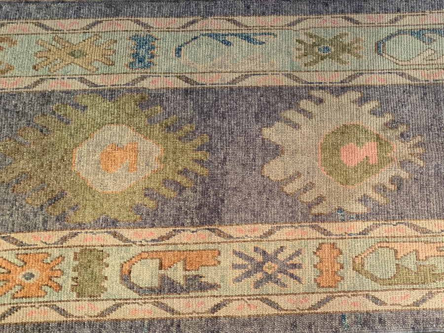 Central medallions on a blue & green Turkish runner rug.