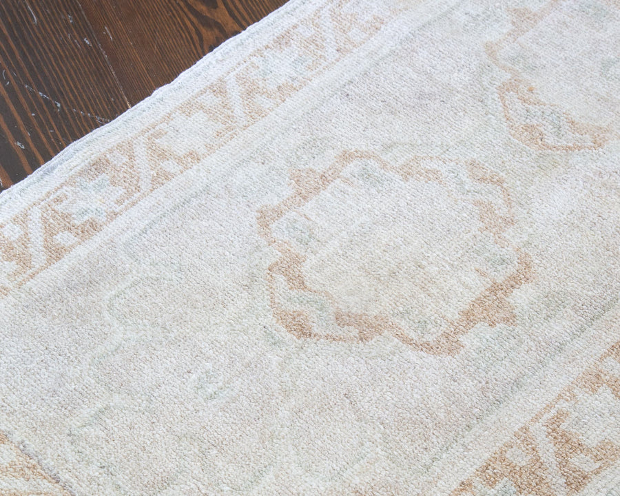 Washed out central medallion of a brown & grey extra small Turkish Yastik Rug.