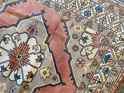 Close up of hand knotting on a large red & orange Konya Turkish rug.