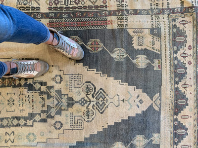 Woman's feet on a large brown & grey Sivas Turkish Rug.