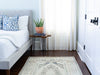 Bedroom with a brown & grey medium sized Sivas Turkish rug.