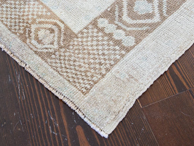 Corner of brown & grey medium sized Sivas Turkish rug.