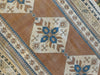 Central repeating medallion on a brown & grey Sultahan runner Turkish rug.