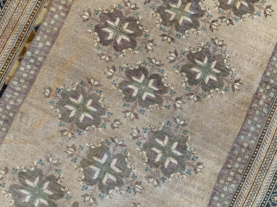 Close up of repeating motif in the middle of a brown & grey small Sivas Turkish Rug.