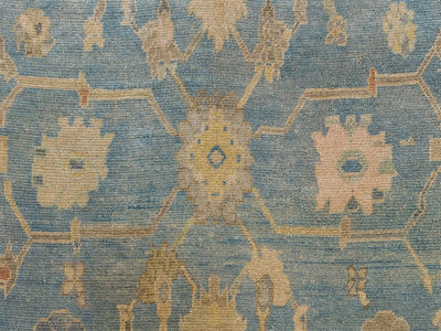 Close up of knots and central medallions on a extra large blue & green Turkish Oushak rug.