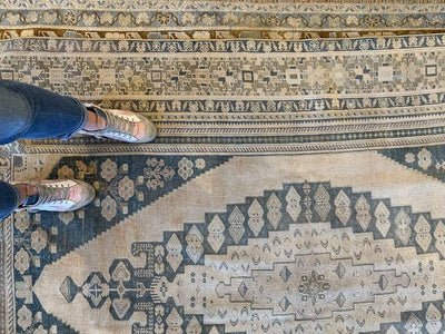 Woman's feel on an extra large brown & grey Sivas Turkish rug.
