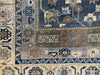 Close up of detailed geometric symbols on an extra large blue and green Sivas Turkish rug.