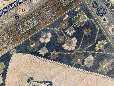 Close up of the corner of a extra large blue and green Sivas Turkish rug.