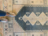 Woman's feet on a brown & grey Sivas Turkish rug.