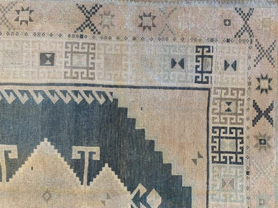Corner of a brown & grey Sivas Turkish rug.