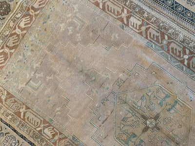 Faded central section of a medium brown and grey Sivas Turkish rug.
