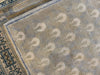 Corner shot of patterned medium brown and grey Sivas Turkish rug.