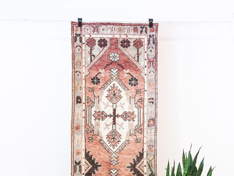Hanging red & orange cal Turkish rug runner.