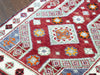 Close up of central medallion on a red & orange extra small Turkish Yastik Rug.