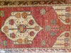 A small red & orange Cal Turkish rug.