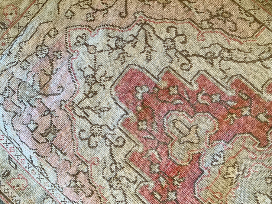 Close up of hand knotting on a medium red & orange Guney Turkish rug.