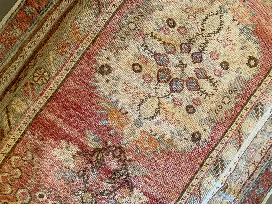 Central medallion on a medium red & orange Guney Turkish rug.