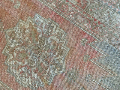 Central medallion on a red & orange small Bor Turkish Rug.