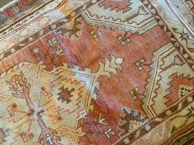 A small red & orange Cal Turkish rug.