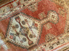 Central medallion on a small red & orange Cal Turkish rug.