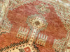 Close up of small red & orange Cal Turkish rug.