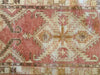 Central medallion and border on a small red & orange Cal Turkish rug.