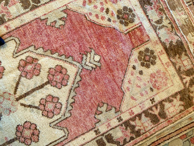 Corner knot-work on a small red & orange Cal Turkish rug.