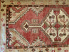 Corner work on a hand knotted small red & orange Cal Turkish rug.