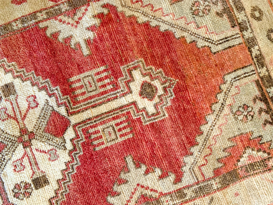 A small red & orange Cal Turkish rug.