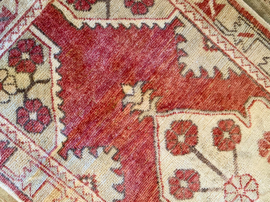 A small red & orange Cal Turkish rug.