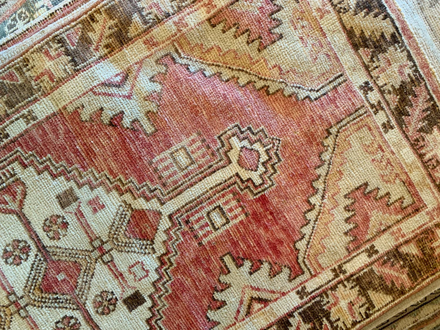 A small red & orange Cal Turkish rug.
