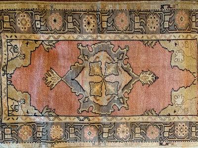 Central medallion and border on a small red & orange Guney Turkish rug.