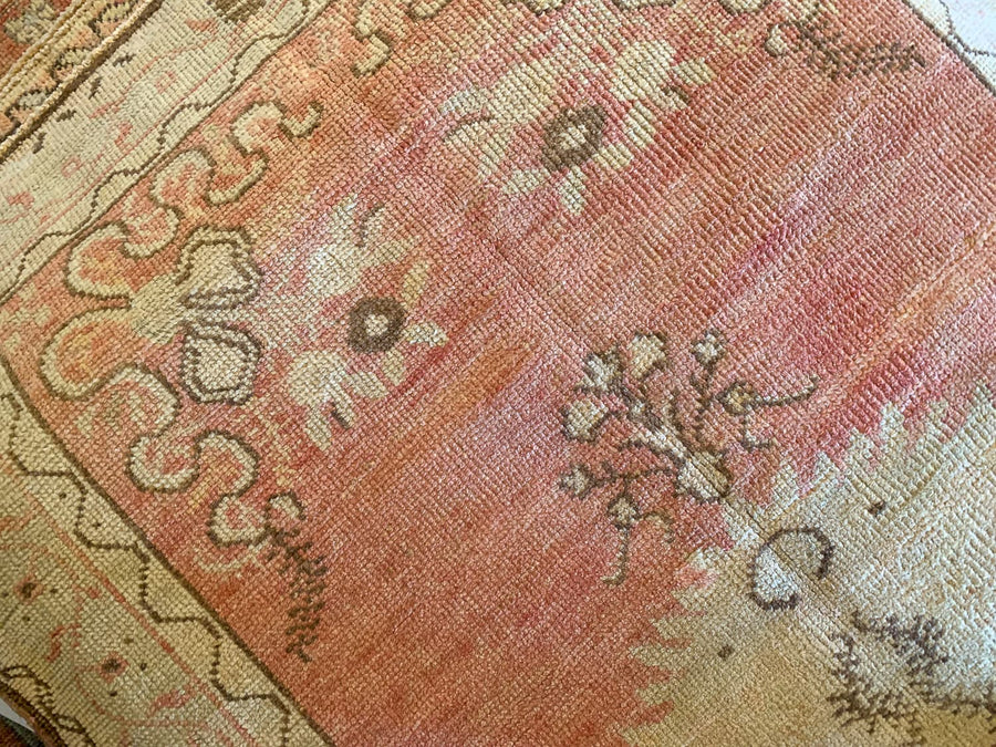 A small red & orange Guney Turkish rug.