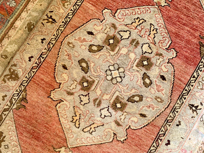 Central medallion on a small red & orange Guney Turkish rug.