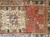 Central motif and and medallion on a small red & orange Guney Turkish rug.