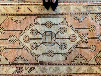 Central medallion on a small red & orange Turkish rug.