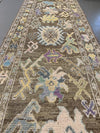 Full view of a brown and grey Turkish runner rug.