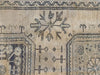 Close up of geometric medallion on a brown & grey Turkish oushak runner.
